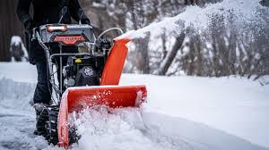 A snow plow is clearing the road in winter.