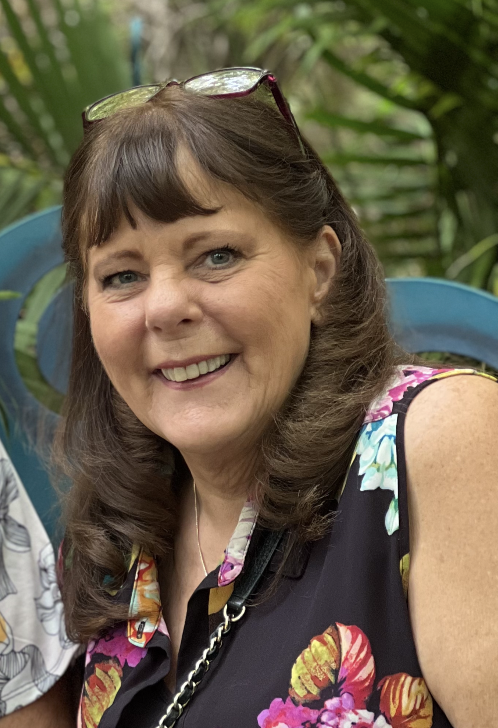 A woman with long hair and cat ears smiles for the camera.